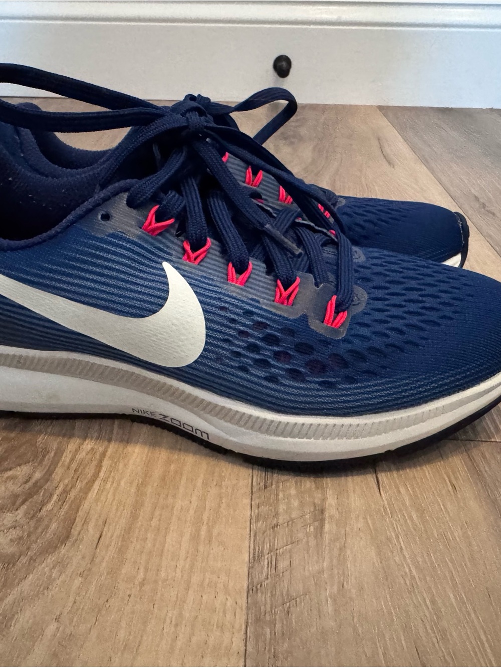 Nike Navy Blue Trainers with White Swoosh and Pink Eyelets